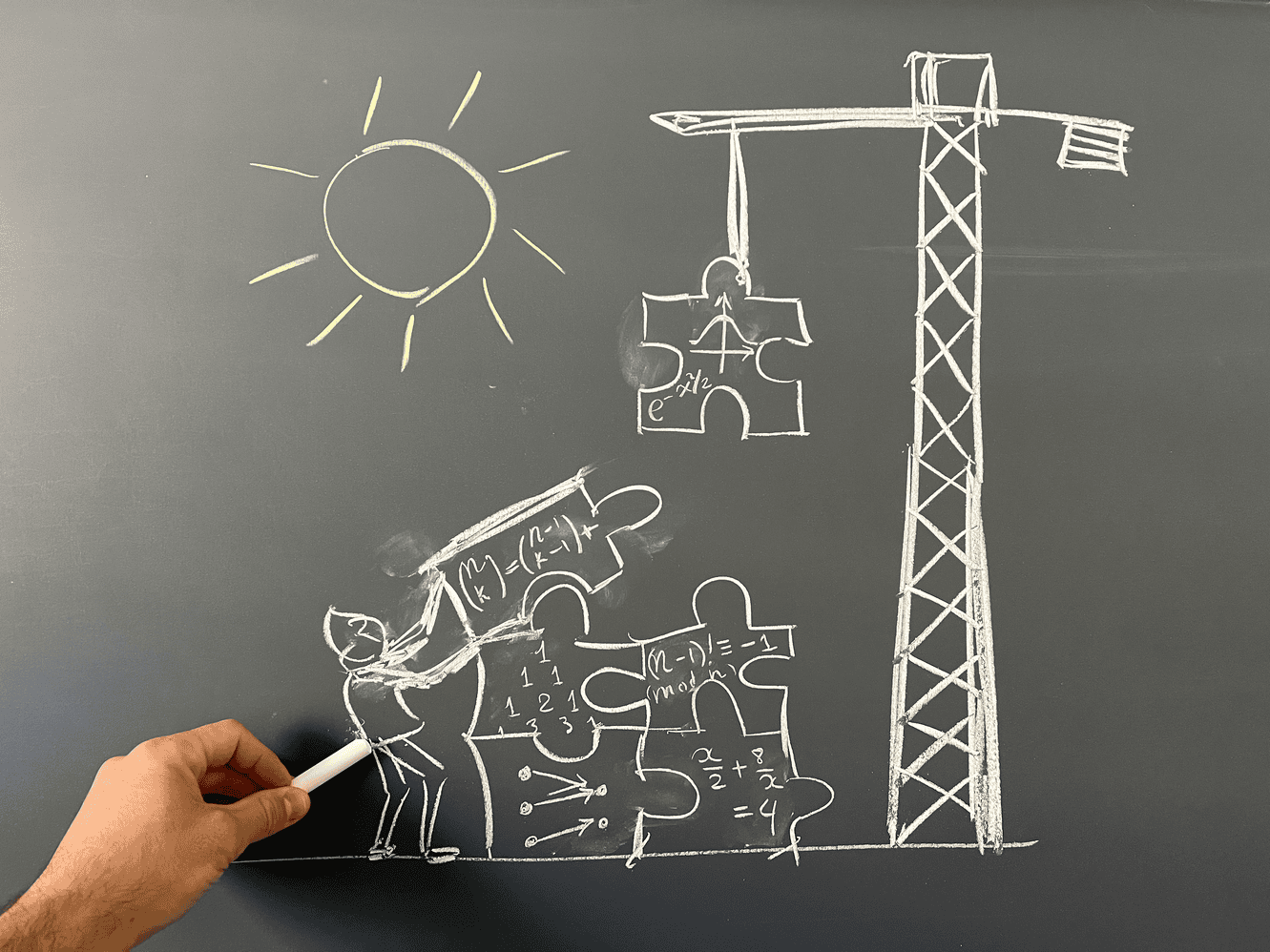 Chalkboard drawing: people collaboratively building a structure with a crane